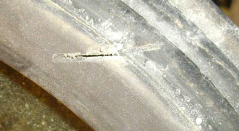 1979 Ford Bronco - Damage to a tire sidewall is visible, with debris stuck in the crack.