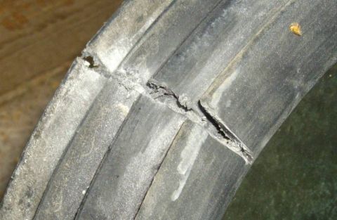 1979 Ford Bronco - Close-up of a damaged tire tread showing a significant split and wear.