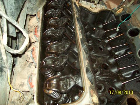 1985 Ford Bronco - The internal components of an engine's valve train are shown, covered in oil.