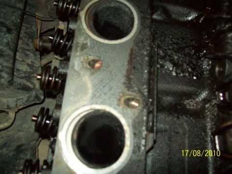 1985 Ford Bronco - Close-up view of an engine's cylinder head, showing valve springs and a date stamp from 2010.
