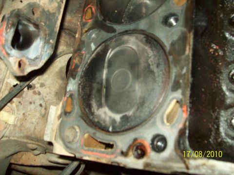 1985 Ford Bronco - Close-up view of an engine's cylinder head, showing wear and carbon deposits.