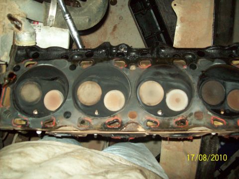1985 Ford Bronco - Close-up view of an engine cylinder head, showing the intake and exhaust valves.