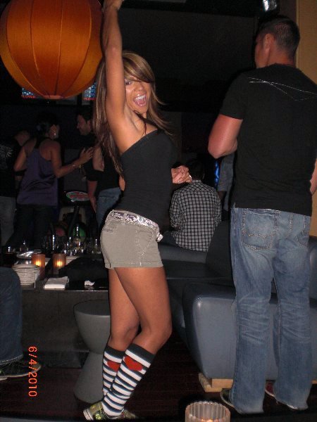 2004 Ford F-150 - A woman enjoys herself while dancing in a crowded nightclub with friends.