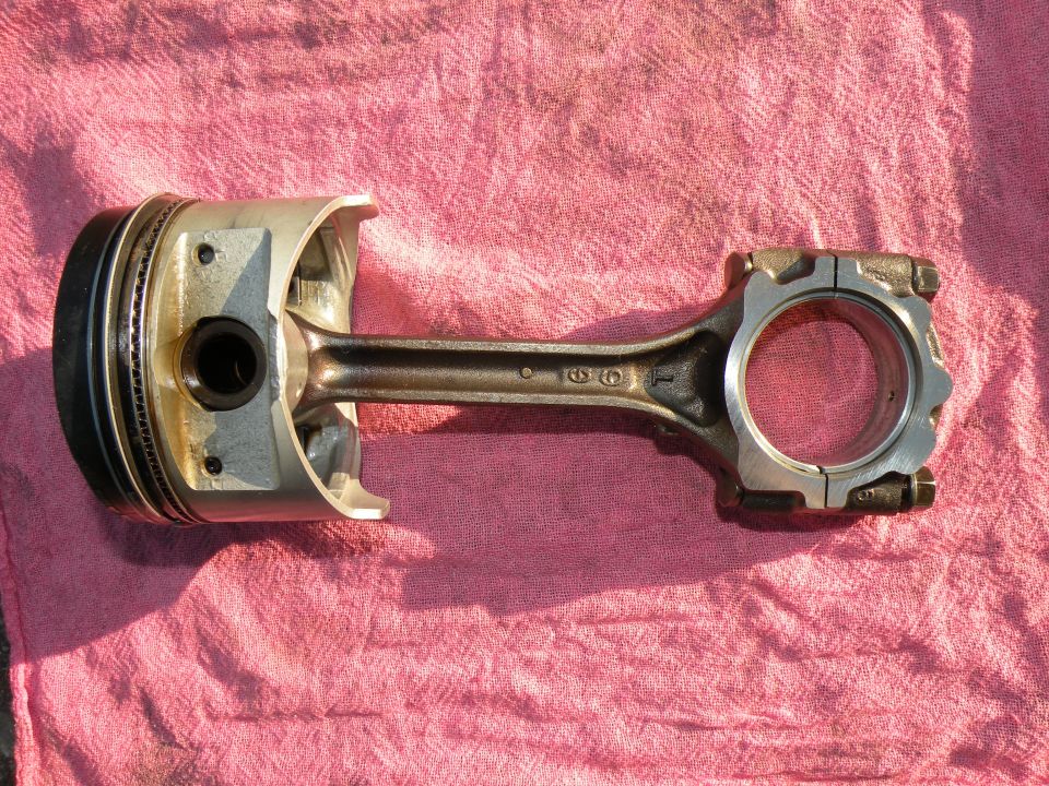 Piston and connecting rod assembly with visible markings '66' and '1'