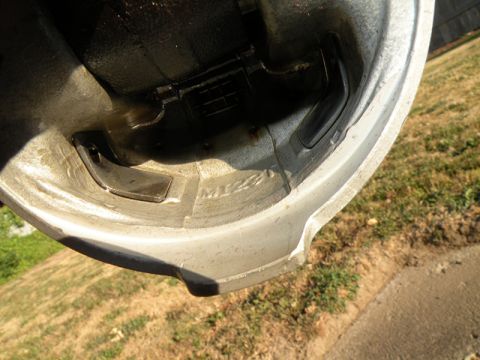 1998 Subaru Legacy - Close-up of an engine piston, with visible casting marks and oil residue.