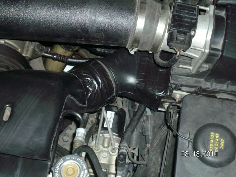 1996 Ford Bronco - Close-up of a modified engine intake system with black tape applied to the tubing.