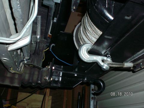 1996 Ford Bronco - Underside view of a winch and hook assembly, showing the steel cable and mounting hardware.