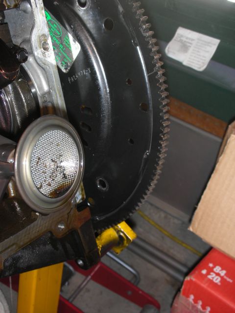1992 Ford Crown Victoria - Close-up view of an engine's oil pickup screen and the teeth of a flywheel.