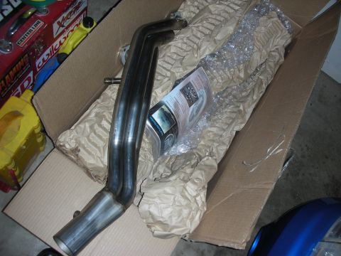 1992 Ford Crown Victoria - New exhaust headers are shown packaged with instructions and bubble wrap inside a cardboard box.