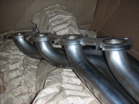 1992 Ford Crown Victoria - New exhaust headers are shown packed in a cardboard box, ready for installation.