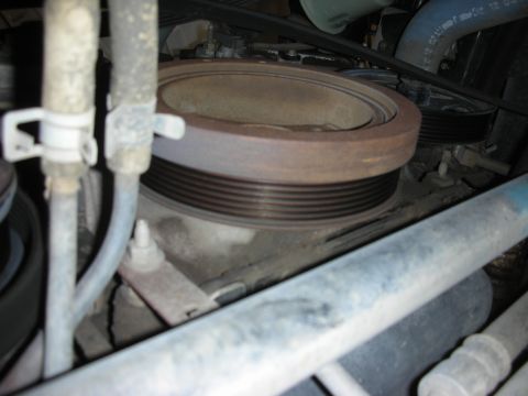 2004 Ford Crown Victoria - Close-up view of a vehicle's engine crankshaft pulley.