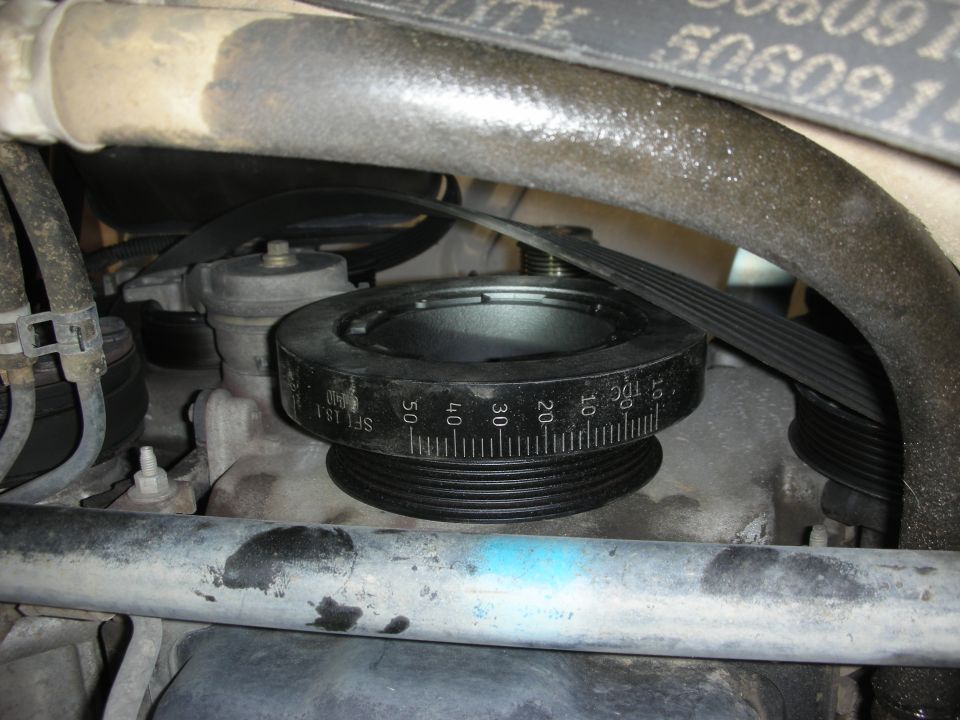 SFI 18.1 harmonic balancer with timing degree marks and serpentine belt on an engine