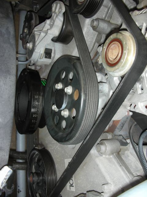 2004 Ford Crown Victoria - Engine bay detail showing serpentine belt system and a marked harmonic balancer, likely for timing adjustments.