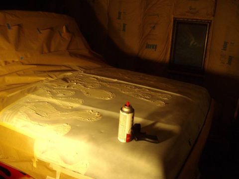 1978 Ford Bronco - A car hood is covered in plastic sheeting and appears to be undergoing some form of repair or modification.