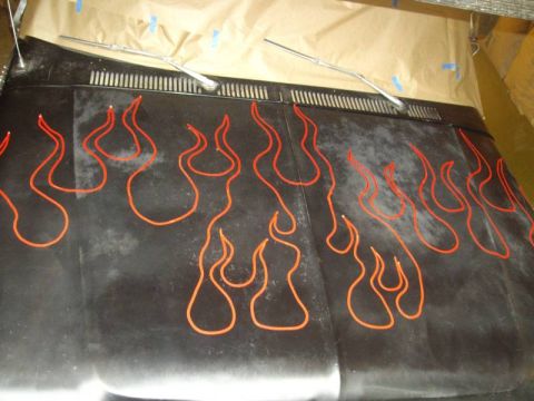 1978 Ford Bronco - A vehicle hood is decorated with orange flame decals and has two windshield wipers visible.