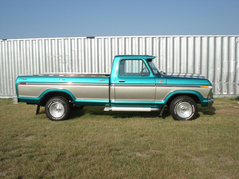 Side view of a 1979 Ford F-150 pickup truck, teal and silver two-tone paint