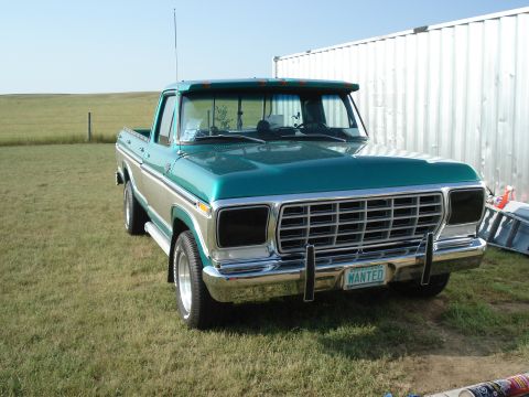 1979 Ford F-150 - This pickup truck has a two-tone paint scheme with a green cab and silver trim. The license plate reads "WANTED".