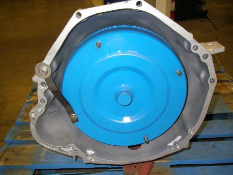 1990 Ford Bronco - Transmission bell housing with a blue torque converter visible inside.