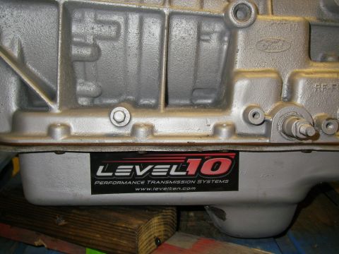 1990 Ford Bronco - A close-up of a transmission pan shows a sticker from Level 10 Performance Transmission Systems.