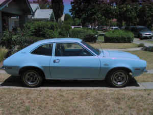 1972 Ford Pinto - A light blue 1972 Ford Pinto coupe is shown from the side in a residential setting.