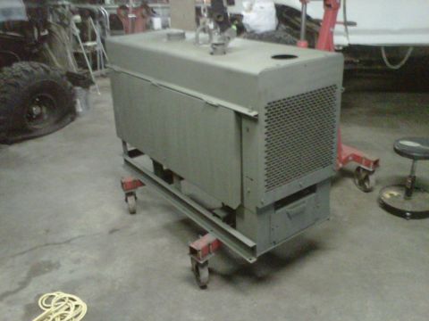 1994 Ford F-150 - A generator sits on a cart in a garage, with a large tire visible to the left.