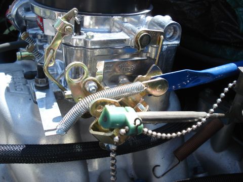 1979 Ford F-150 - Close-up view of carburetor linkage, showing springs, levers, and a green plastic component.