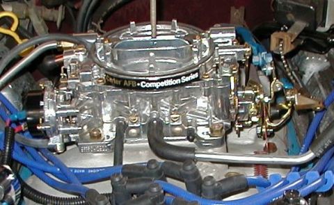 1979 Ford F-150 - A detailed view of a chrome carburetor, likely a Carter AFB Competition Series, with associated engine components and wiring.