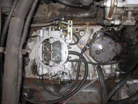 1979 Ford F-150 - Engine compartment detail showing a carburetor and fuel pump assembly.