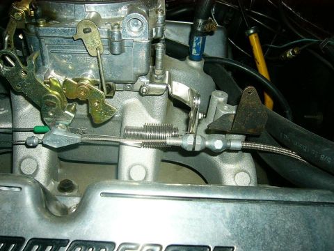 1979 Ford F-150 - This image shows a close-up view of a vehicle's carburetor and associated throttle linkage system.