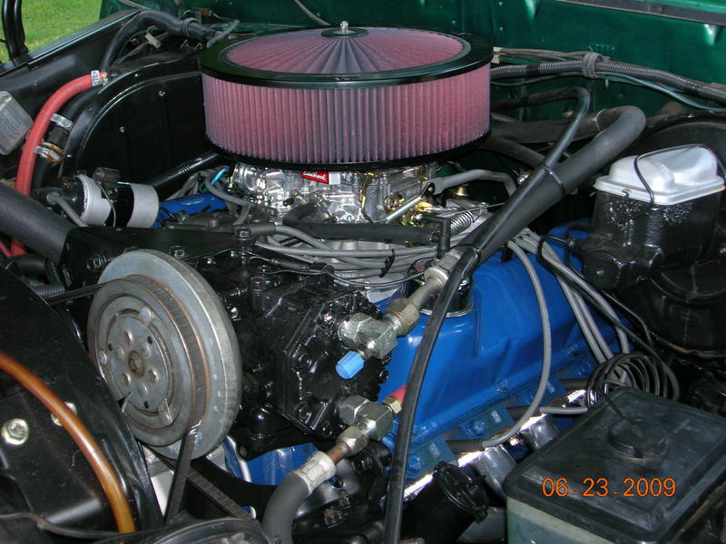Green 1979 Ford F-150 engine bay with a large red air filter over a carburetor