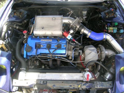 1995 Ford Probe - Engine bay view of a modified Mazda engine a turbocharger and intercooler system.