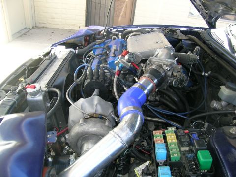 1995 Ford Probe - Customized engine bay with aftermarket turbocharger and intercooler components.