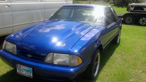 1979 Ford F-150 - This blue coupe features an aftermarket hood scoop and custom hood pins, suggesting modifications beyond its original design.