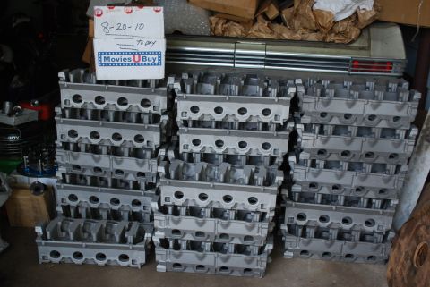 1969 Ford Fairlane - Numerous engine cylinder heads are stacked in a workshop, with a box indicating a date of 8-20-10 visible.