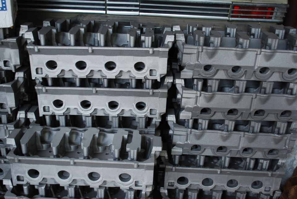 Stacks of raw unmachined V8 cylinder head castings