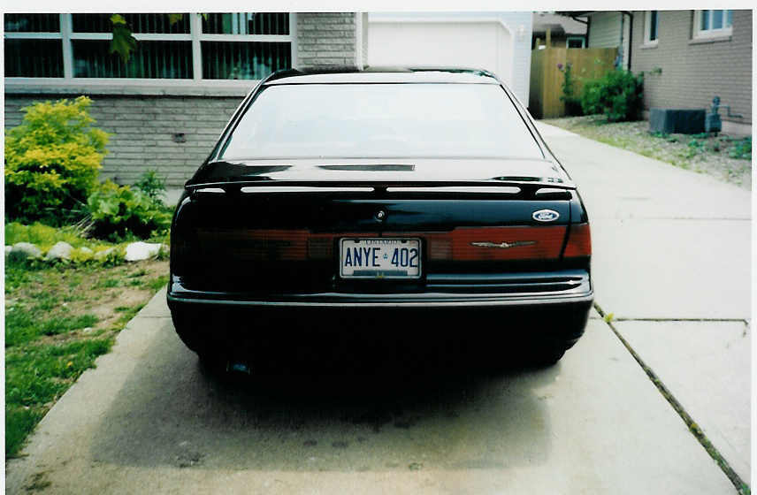 Black 1990 Ford Thunderbird rear view, license plate ANYE 402