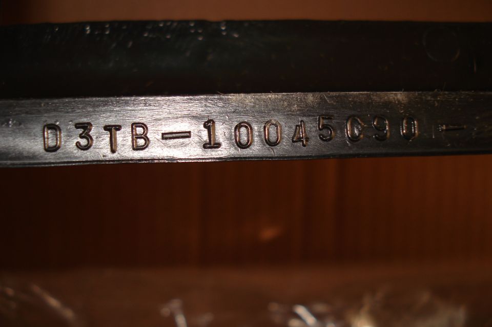 Part with stamped numbers D3TB-10045090