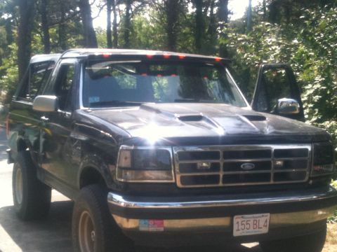 1993 Ford Bronco - This black Ford Bronco has a custom hood and a light bar above the windshield.