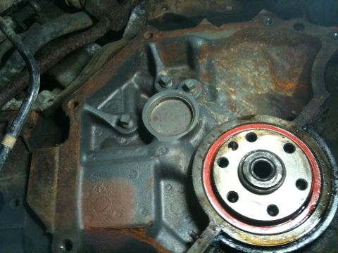 1993 Ford Bronco - This is a close-up view of an engine block part, showing rust and mechanical components.