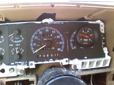 1990 Ford Bronco - Close-up of a vehicle's dashboard gauges, including a speedometer and RPM meter, with the odometer showing 19365 miles.