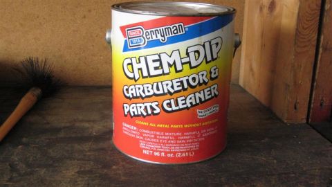 1968 Ford Ranchero - A can of carburetor cleaner and a brush sit on a wooden surface.