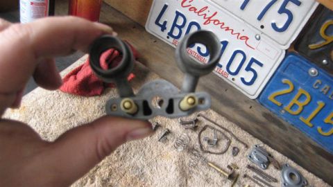 1968 Ford Ranchero - A close-up view of a carburetor component with various screws and springs scattered around it.