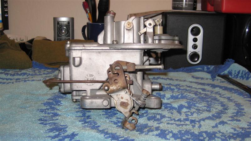 carburetor with linkage and springs, sitting on a blue towel