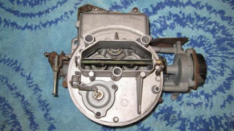 1968 Ford Ranchero - A close-up view of a carburetor, showing its intricate mechanical parts and internal workings.