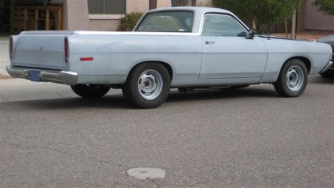 1968 Ford Ranchero - This light blue Ford Ranchero pickup truck is parked on a street, showing its side profile.