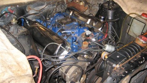 1968 Ford Ranchero - Close-up view of a vehicle's engine bay, showing the intricate network of hoses and wiring.