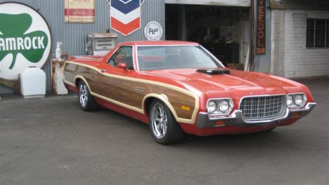 1968 Ford Ranchero - This red woody wagon-truck has a distinctive grille and wood paneling, suggesting a 1970 model year.