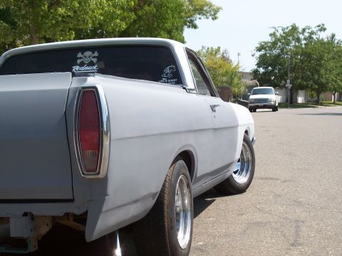 1968 Ford Ranchero - Rear view of a primer-finished 1968 Ford Ranchero with custom stickers on the window.