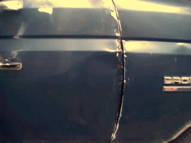 1989 Ford Bronco side door panel with "BRONCO" badge visible