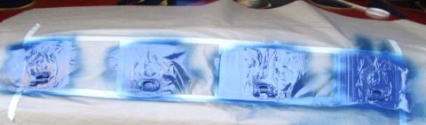1978 Ford Bronco - Hood letters are being spray painted blue on a white sheet.